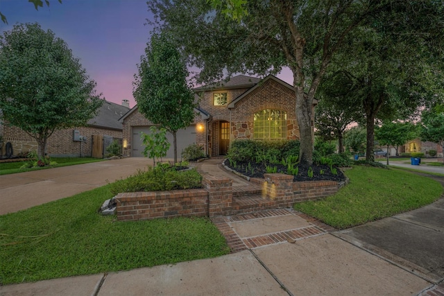 18419 W Willow Oak Bend Dr, Cypress, TX 77433 - traditional-style house featuring driveway, brick siding, a yard, and an attached garage