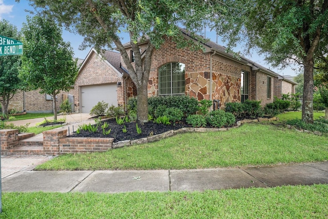 18419 W Willow Oak Bend Dr, Cypress, TX 77433 - view of front facade featuring a front lawn, a garage, brick siding, concrete driveway, and stone siding