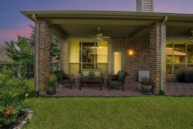 18419 W Willow Oak Bend Dr, Cypress, TX 77433 - back of property at dusk with an outdoor living space, a patio, brick siding, and a chimney