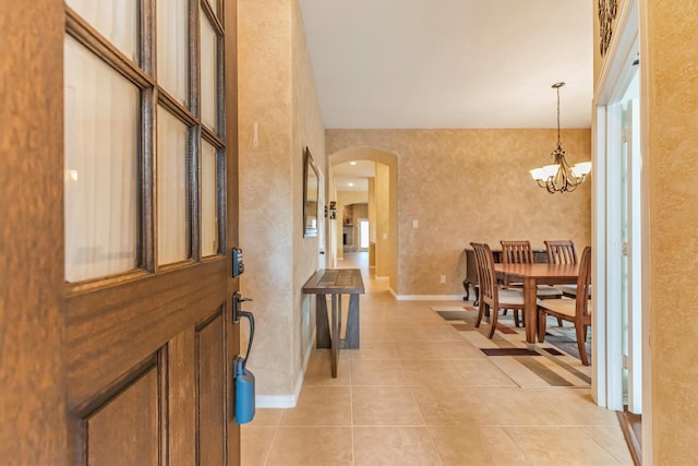 18419 W Willow Oak Bend Dr, Cypress, TX 77433 - foyer entrance featuring arched walkways, a chandelier, and light tile patterned flooring