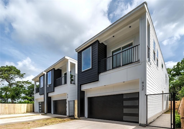 1911 Dewalt St, Houston, TX 77088 - view of front of home featuring a balcony, a garage, and driveway