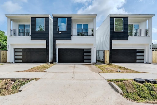1911 Dewalt St, Houston, TX 77088 - view of front of house featuring an attached garage, a balcony, and concrete driveway