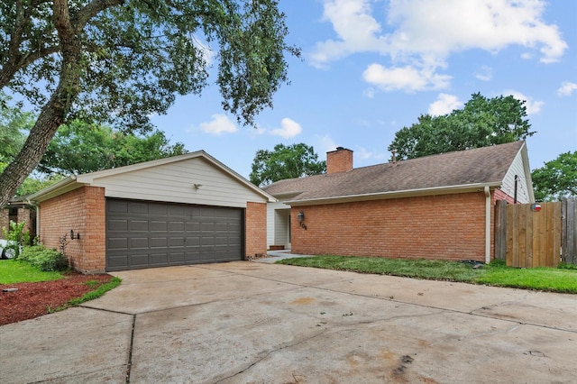 706 Geronimo Ct, Katy, TX 77450 - view of front of house featuring brick siding, a chimney, a detached garage, and an outbuilding