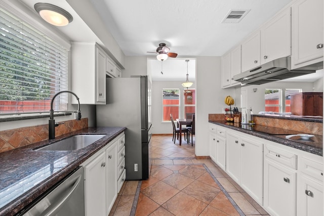 706 Geronimo Ct, Katy, TX 77450 - kitchen featuring stainless steel appliances, a ceiling fan, under cabinet range hood, white cabinets, and dark stone countertops