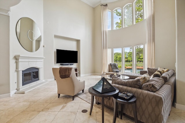 3319 Bridgeberry Ln, Houston, TX 77082 - living room with a high ceiling, a high end fireplace, crown molding, and light tile patterned floors