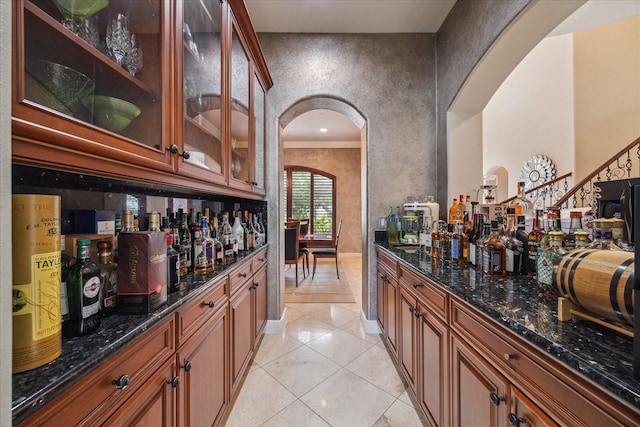 3319 Bridgeberry Ln, Houston, TX 77082 - indoor dry bar featuring arched walkways and light tile patterned flooring