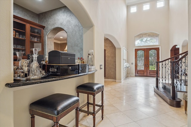 3319 Bridgeberry Ln, Houston, TX 77082 - entrance foyer with arched walkways, a towering ceiling, tile patterned floors, stairway, and french doors