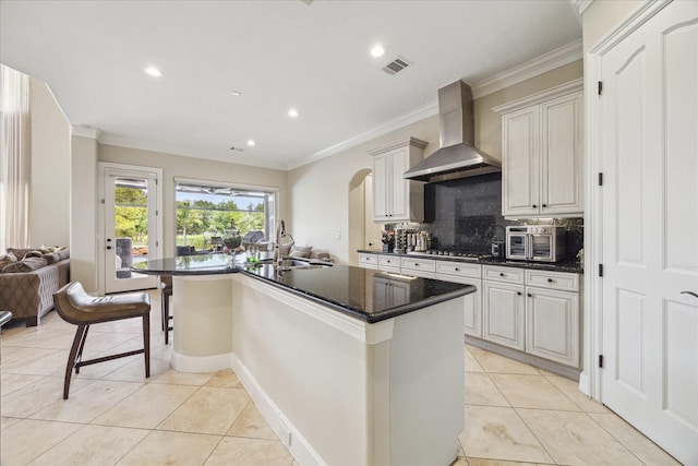 3319 Bridgeberry Ln, Houston, TX 77082 - kitchen with exhaust hood, light tile patterned flooring, crown molding, stainless steel gas cooktop, and recessed lighting