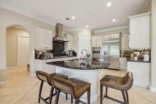 3319 Bridgeberry Ln, Houston, TX 77082 - kitchen with stainless steel appliances, wall chimney range hood, backsplash, light tile patterned floors, and recessed lighting