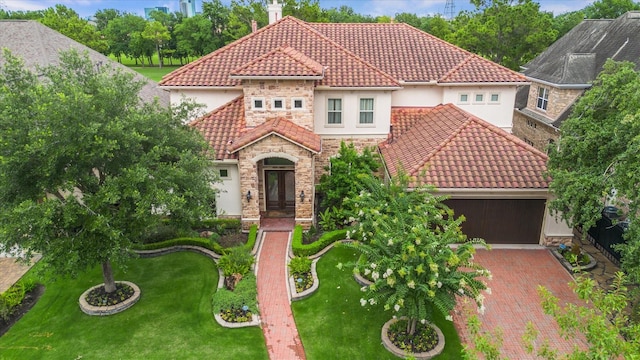 3319 Bridgeberry Ln, Houston, TX 77082 - mediterranean / spanish-style house featuring a tile roof, stucco siding, stone siding, and a front lawn
