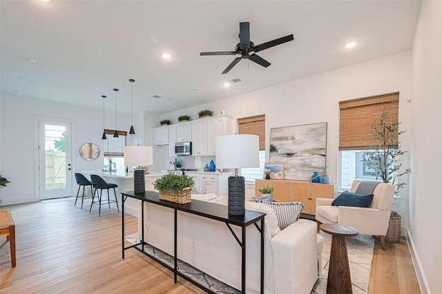 2710 Bostic St, Houston, TX 77093 - living room with light wood finished floors, a ceiling fan, and recessed lighting