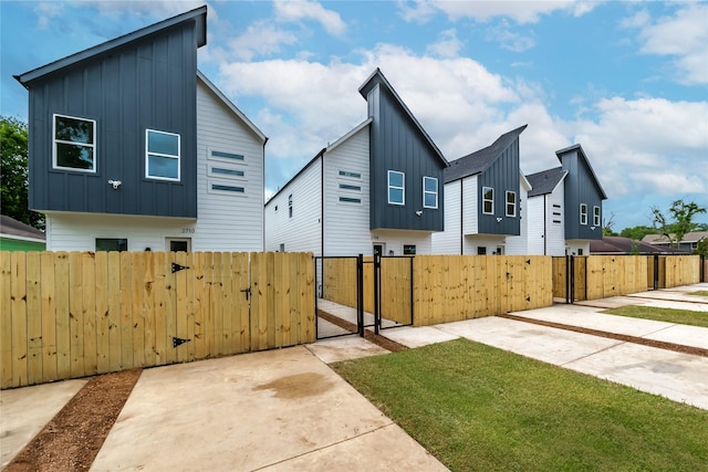 2710 Bostic St, Houston, TX 77093 - view of side of home featuring board and batten siding and a gate