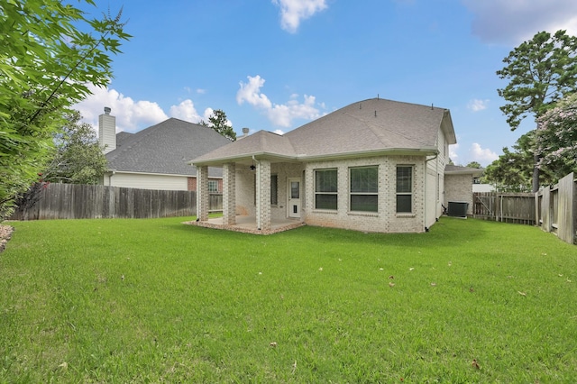 13310 Hidden Valley Dr, Montgomery, TX 77356 - back of property with a fenced backyard, brick siding, a patio area, and roof with shingles