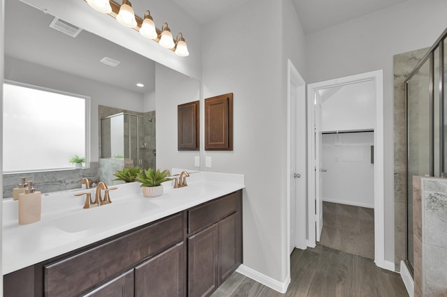13310 Hidden Valley Dr, Montgomery, TX 77356 - bathroom with a shower stall, a spacious closet, double vanity, and wood finished floors
