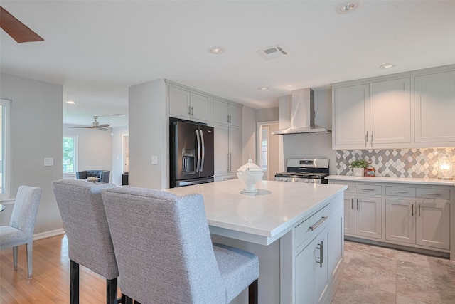 5123 Saxon Dr, Houston, TX 77092 - kitchen featuring range hood, fridge with ice dispenser, stainless steel stove, a ceiling fan, and tasteful backsplash