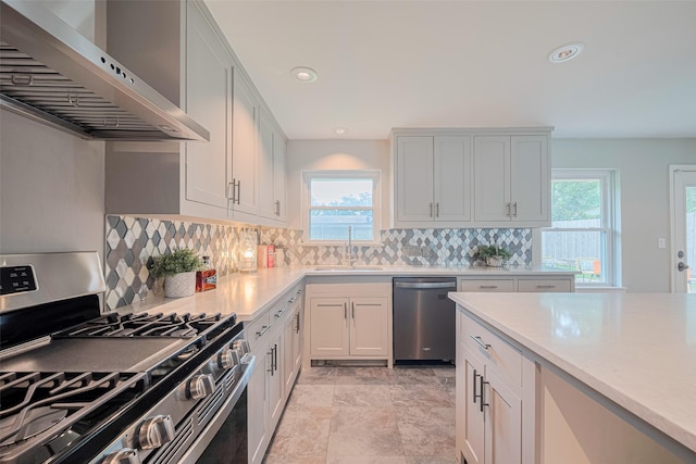 5123 Saxon Dr, Houston, TX 77092 - kitchen with stainless steel appliances, range hood, tasteful backsplash, recessed lighting, and light countertops