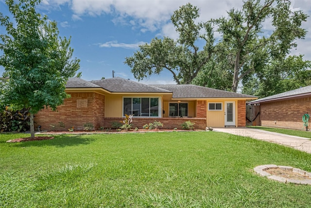 5123 Saxon Dr, Houston, TX 77092 - ranch-style home with brick siding, a front lawn, roof with shingles, and driveway