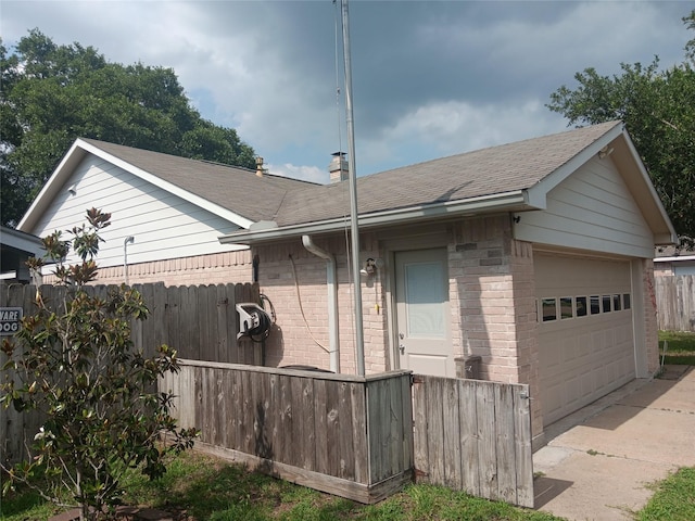 18602 Lippizaner Dr, Cypress, TX 77433 - view of property exterior with a garage, roof with shingles, and brick siding
