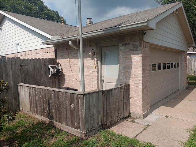 18602 Lippizaner Dr, Cypress, TX 77433 - view of home's exterior with brick siding, a shingled roof, and a detached garage