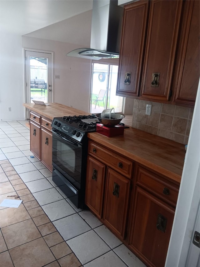18602 Lippizaner Dr, Cypress, TX 77433 - kitchen with wall chimney exhaust hood, black range with gas cooktop, butcher block counters, and light tile patterned flooring