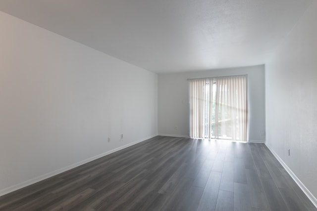 3025 Walnut Bend Ln Unit 37, Houston, TX 77042 - unfurnished room with dark wood-type flooring and baseboards