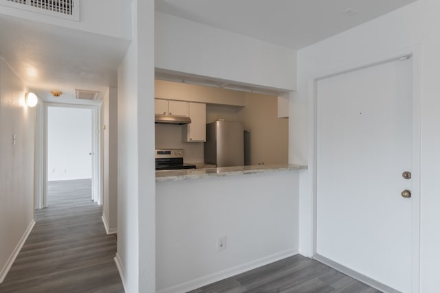 3025 Walnut Bend Ln Unit 37, Houston, TX 77042 - kitchen featuring stainless steel appliances, under cabinet range hood, dark wood finished floors, and light stone counters