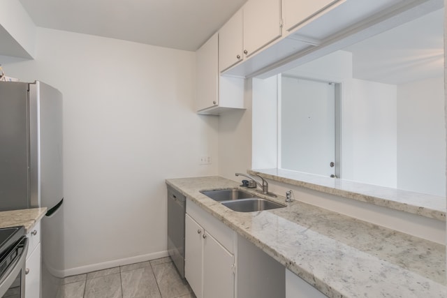 3025 Walnut Bend Ln Unit 37, Houston, TX 77042 - kitchen with appliances with stainless steel finishes, white cabinetry, and light stone counters