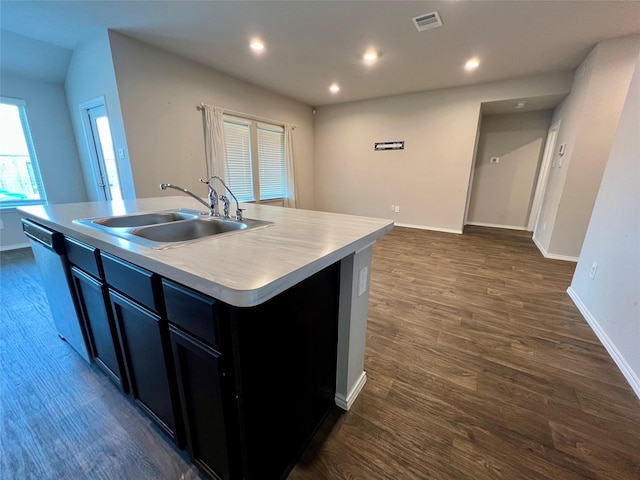 21540 Rustic Elm Dr, New Caney, TX 77357 - kitchen featuring stainless steel dishwasher, an island with sink, dark wood-type flooring, light countertops, and recessed lighting