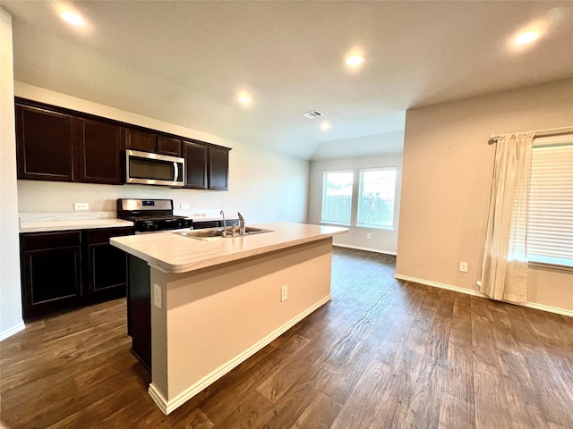 21540 Rustic Elm Dr, New Caney, TX 77357 - kitchen with stainless steel microwave, gas range oven, light countertops, dark wood finished floors, and recessed lighting