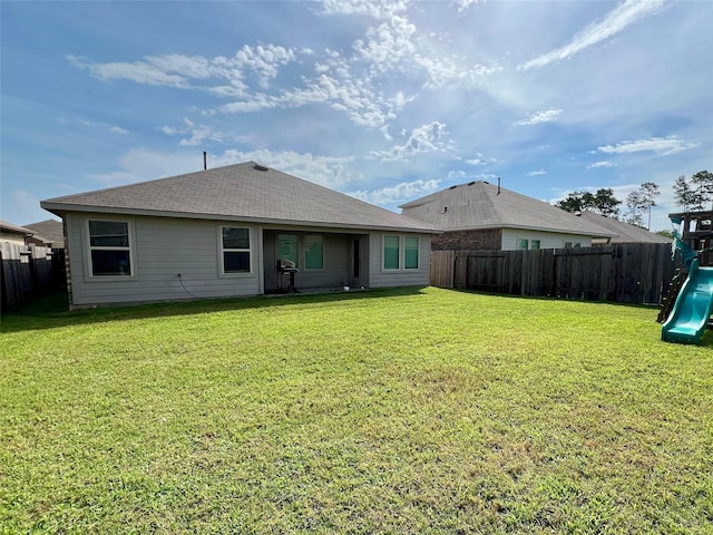 21540 Rustic Elm Dr, New Caney, TX 77357 - back of property with a playground, a fenced backyard, and a shingled roof