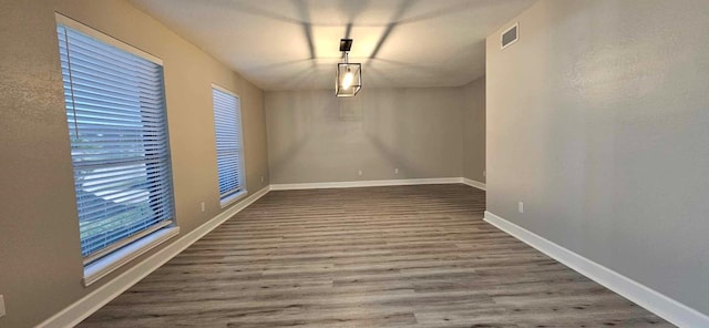 47 W Dansby Dr, Galveston, TX 77551 - unfurnished dining area with wood finished floors and healthy amount of natural light