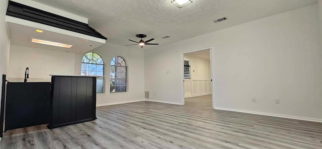 47 W Dansby Dr, Galveston, TX 77551 - unfurnished living room featuring a textured ceiling, wood finished floors, and ceiling fan