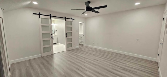 47 W Dansby Dr, Galveston, TX 77551 - unfurnished bedroom featuring a barn door, recessed lighting, wood finished floors, and ceiling fan