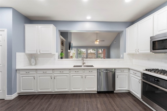 14619 Townsend Ct, Cypress, TX 77429 - kitchen with stainless steel appliances, ceiling fan, decorative backsplash, white cabinets, and recessed lighting