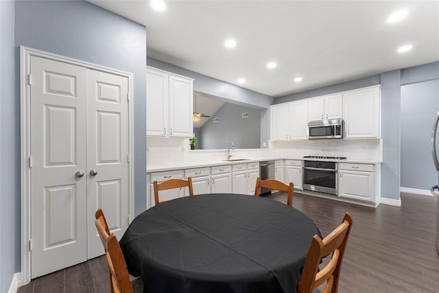 14619 Townsend Ct, Cypress, TX 77429 - kitchen featuring appliances with stainless steel finishes, backsplash, white cabinetry, recessed lighting, and light countertops