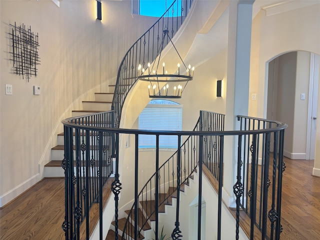 607 Oakley St Unit 5, Houston, TX 77006 - stairway with a towering ceiling, wood finished floors, arched walkways, and a chandelier