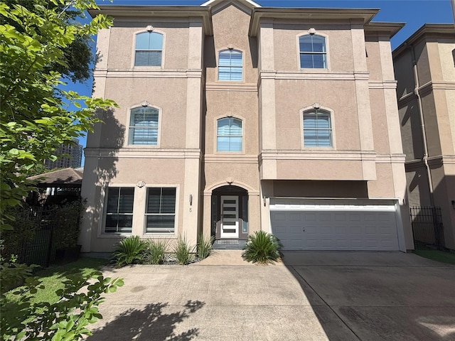 607 Oakley St Unit 5, Houston, TX 77006 - townhome / multi-family property featuring concrete driveway, a garage, and stucco siding