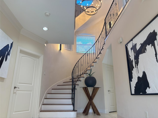 607 Oakley St Unit 5, Houston, TX 77006 - staircase with a chandelier, a high ceiling, and ornamental molding