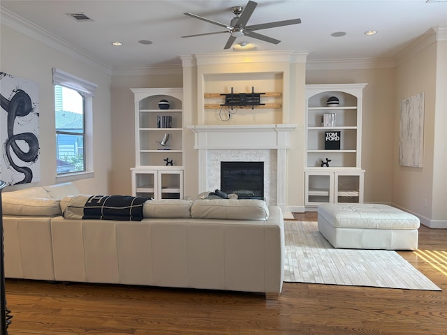 607 Oakley St Unit 5, Houston, TX 77006 - living room featuring wood finished floors, a glass covered fireplace, a ceiling fan, ornamental molding, and recessed lighting