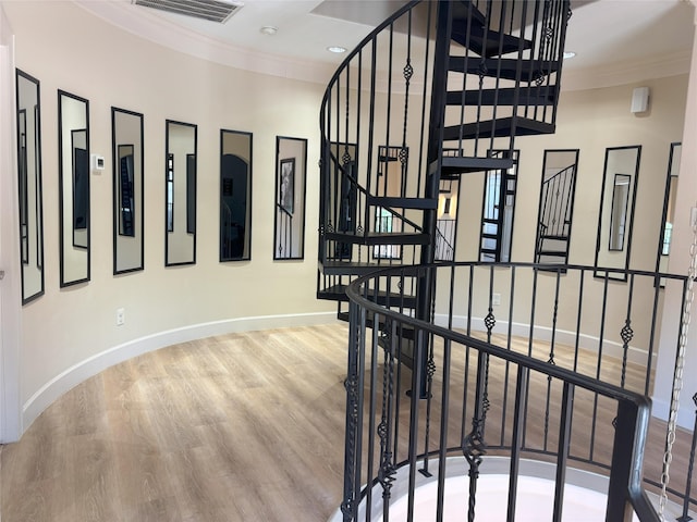 607 Oakley St Unit 5, Houston, TX 77006 - stairway with crown molding, wood finished floors, and recessed lighting