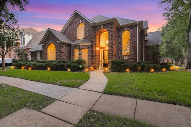 3402 Haywood Ct, Sugar Land, TX 77478 - traditional-style home with brick siding, a yard, and a shingled roof