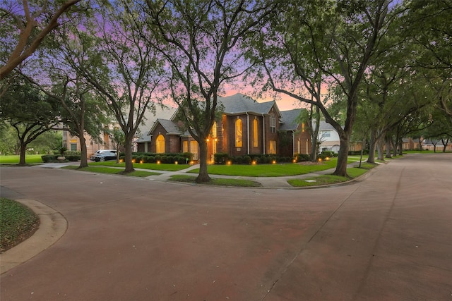 3402 Haywood Ct, Sugar Land, TX 77478 - view of front of home featuring a yard, brick siding, and curved driveway