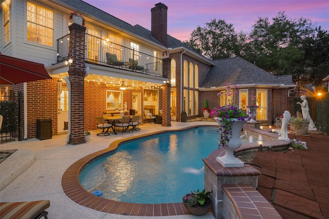 3402 Haywood Ct, Sugar Land, TX 77478 - pool at dusk featuring a patio and an outdoor pool