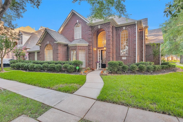 3402 Haywood Ct, Sugar Land, TX 77478 - traditional-style house with brick siding, a front lawn, and roof with shingles
