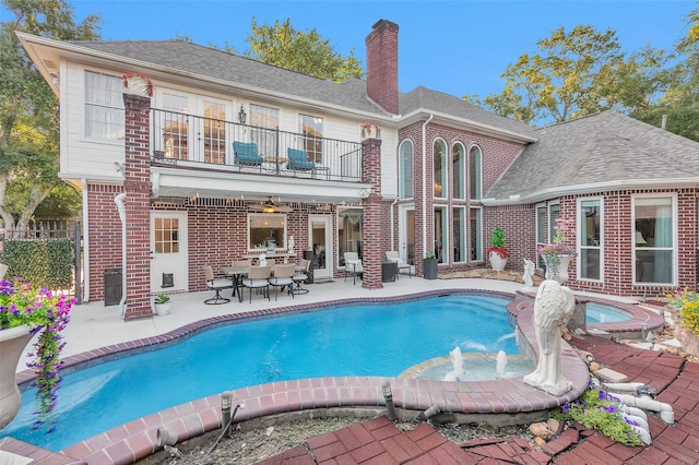 3402 Haywood Ct, Sugar Land, TX 77478 - rear view of property with a balcony, a jacuzzi, brick siding, and a patio