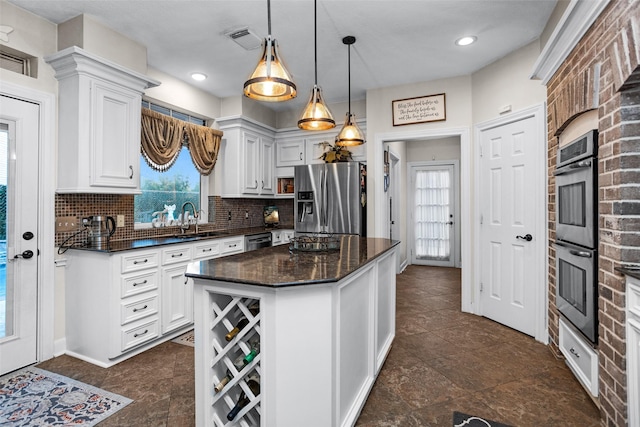 3402 Haywood Ct, Sugar Land, TX 77478 - kitchen with appliances with stainless steel finishes, plenty of natural light, tasteful backsplash, and white cabinets