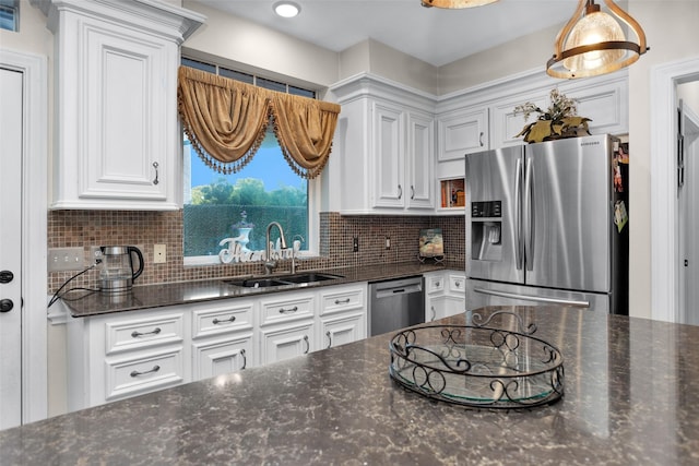 3402 Haywood Ct, Sugar Land, TX 77478 - kitchen featuring appliances with stainless steel finishes, white cabinetry, tasteful backsplash, and dark stone countertops