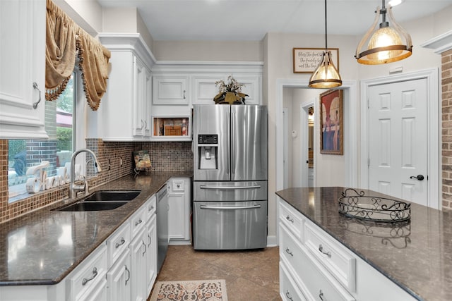 3402 Haywood Ct, Sugar Land, TX 77478 - kitchen with appliances with stainless steel finishes, white cabinetry, tasteful backsplash, and hanging light fixtures