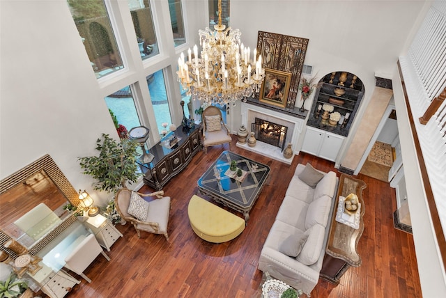 3402 Haywood Ct, Sugar Land, TX 77478 - living room with a high ceiling, a chandelier, a premium fireplace, and wood finished floors