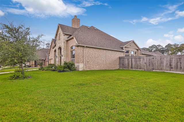 18115 Stari Most Ln, Houston, TX 77044 - view of side of home featuring brick siding, roof with shingles, and a chimney